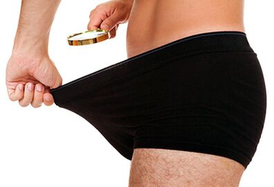 a man looking at his penis size